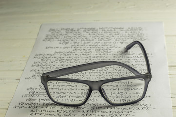 Eyeglasses on Background of Mathh Formula Sheet