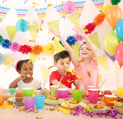 Cute little children celebrating birthday at party