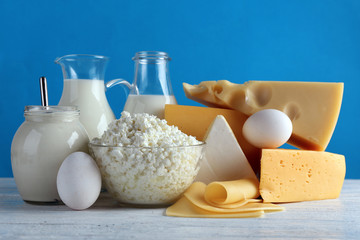 Set of fresh dairy products on color background