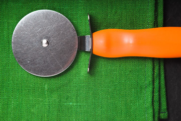 Pizza knife on a bright green napkin