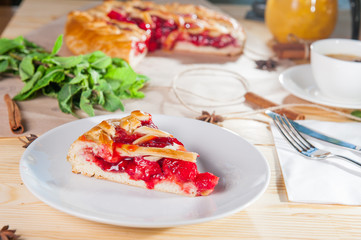 Piece of sweet pie, tart, cake with jellied fresh strawberries on the white plate on the wooden served table. Close up, Selective Focus