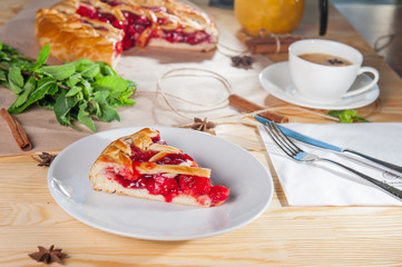 Piece of sweet pie, tart, cake with jellied fresh strawberries on the white plate on the wooden served table. Close up, Selective Focus