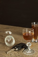 Alcohol and driving. Danger on the roads. Alcoholic behind the wheel. Car keys on the bar.
