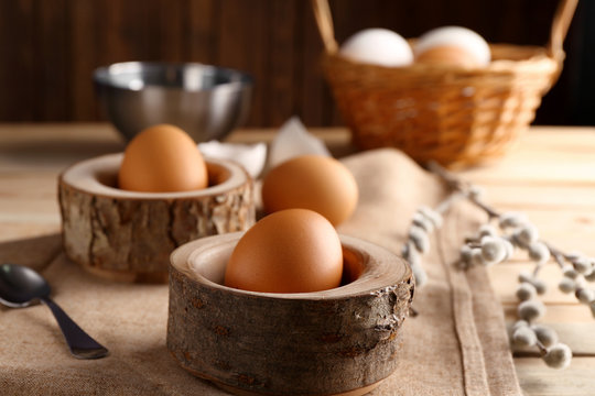 Wooden stands with Ester eggs on linen tablecloth