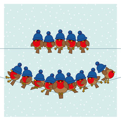 Robins wearing Blue Woolly Bobble Hats on two Telephone Wires