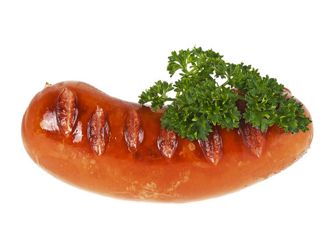 Tasty grilled sausage and twig of parsley on a white background