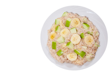 oatmeal with apple and bananas slices. top view. isolated on white