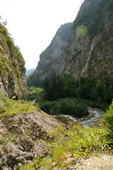 Fototapeta na wymiar An old logging road running along the canyon, along the Gega River in Abkhazia, the Caucasus
