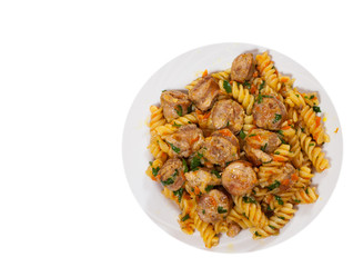 Fusilli pasta with sausage and vegetables. top view. isolated on white