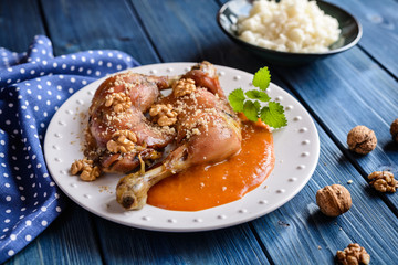 Roasted chicken thighs sprinkled with walnuts, served with apricot sauce and rice