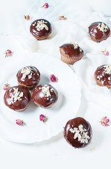 Chocolate cupcakes on grunge white wooden background