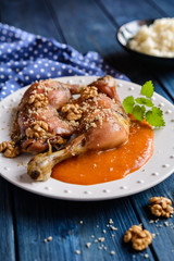 Roasted chicken thighs sprinkled with walnuts, served with apricot sauce and rice