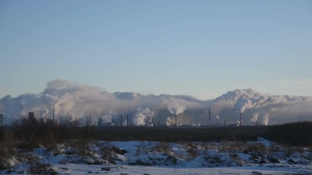massive air pollution, huge factory smokes on the horizon