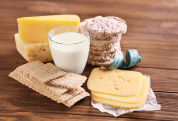Different dairy products on wooden background