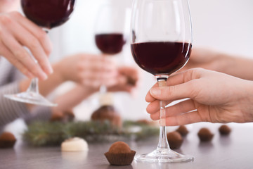 Female hand holding glass of red wine closeup