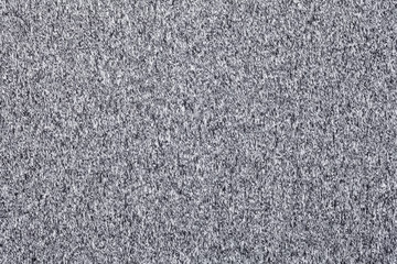 Grey melange knitted fabric made of synthetic fibres textured background