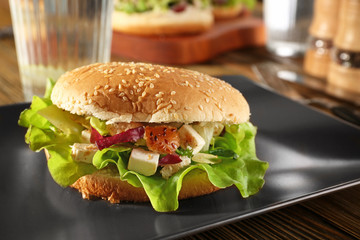 Plate with chicken salad in burger bun, closeup
