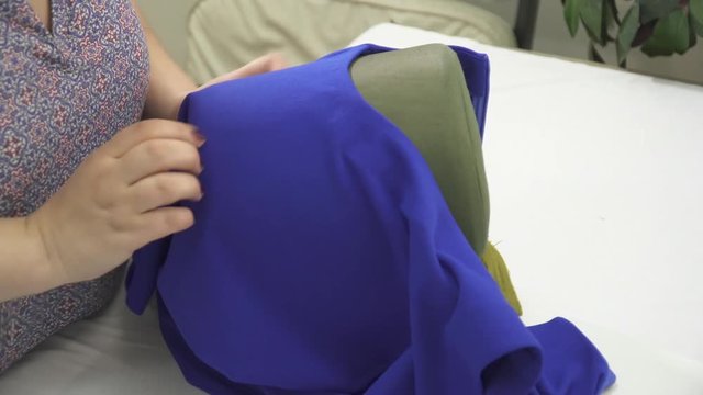 Woman's hands ironing the beautiful dress closeup