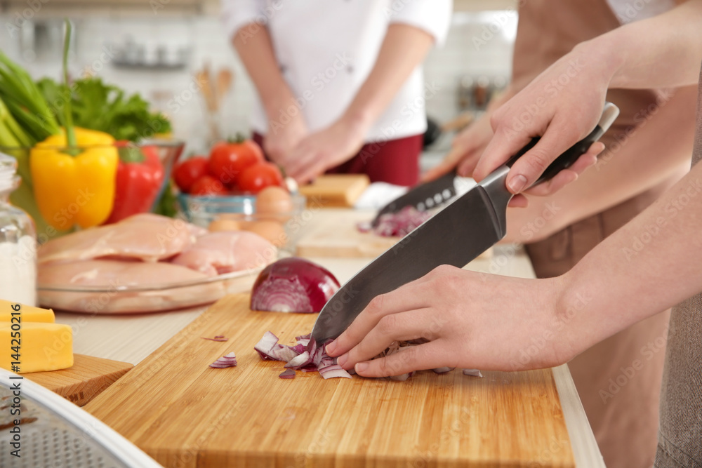 Poster people cutting onion at cooking classes