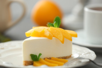 Tasty cheesecake slice with fruit on plate