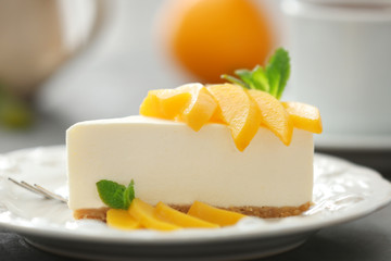 Tasty cheesecake slice with fruit on plate