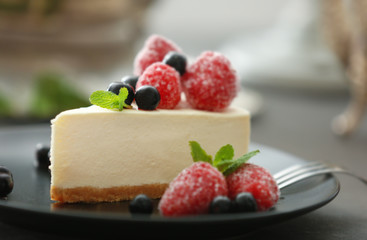 Tasty cheesecake slice with berries on plate