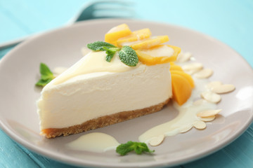 Tasty cheesecake slice with fruit on plate
