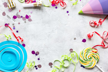 party set with hat, lollipop and confetti stone background top view mock-up