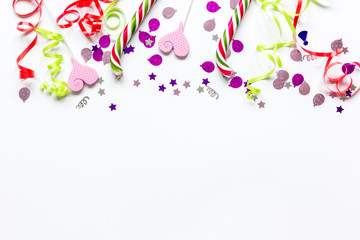 Colored party sweets and confetti on white background top view mockup