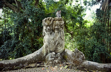 stone sculpture of a group of monkeys live monkey in a tropical green forest