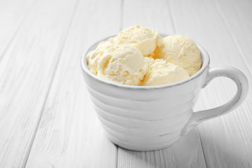 Tasty ice-cream in cup on table