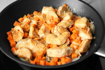 Chicken stir fry with vegetables in pan, closeup