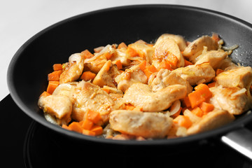 Chicken stir fry with vegetables in pan, closeup