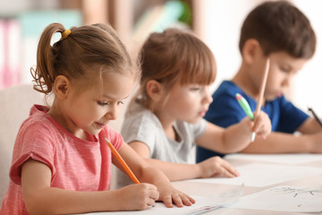 Cute kids drawing in classroom