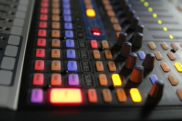 Professional audio operator working on audio mixer knobs during live TV telecast