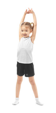 Cute girl doing gymnastic exercises on white background