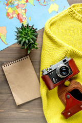 traveller set with camera and map on wooden background top view