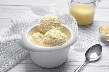 Tasty ice cream with coconut flakes in bowl