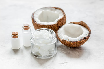 Obraz na płótnie Canvas coconut oil for body care in cosmetic concept on white desk