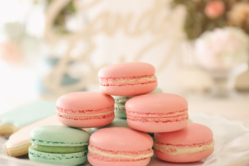 Plate with macarons on blurred background