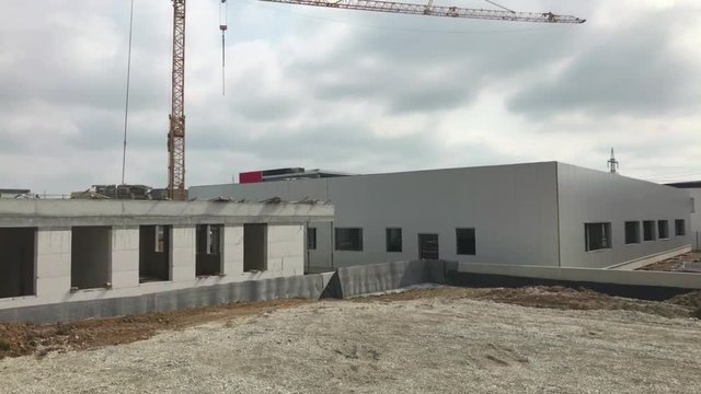 Booming logistics - panorama of a van in front of newly built warehouses