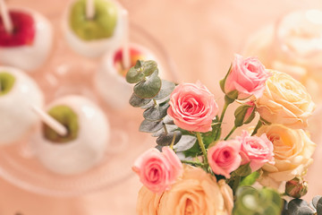 Beautiful flower bouquet on table with sweets