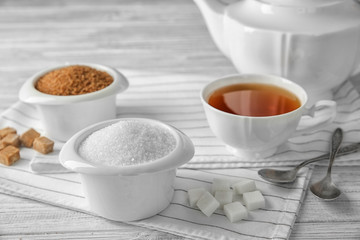 Beautiful composition with sugar on wooden table