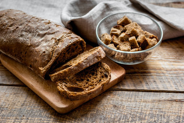 traditional sliced bread with crumbs wooden table background