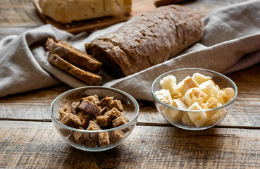 making crumbs from rye and wheat bread wooden background