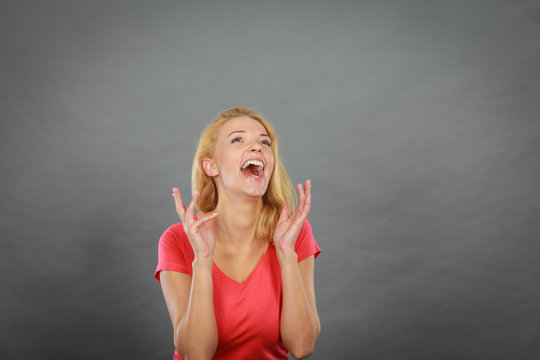 Blonde woman being happy and screaming
