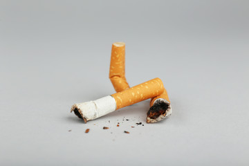 Cigarette butts on light background