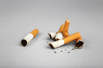 Cigarette butts on light background