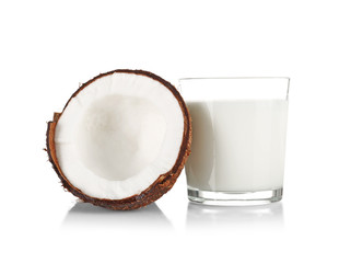 Glass of coconut milk with nut on white background