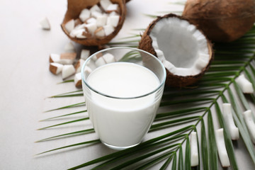 Composition with fresh coconut milk on light background